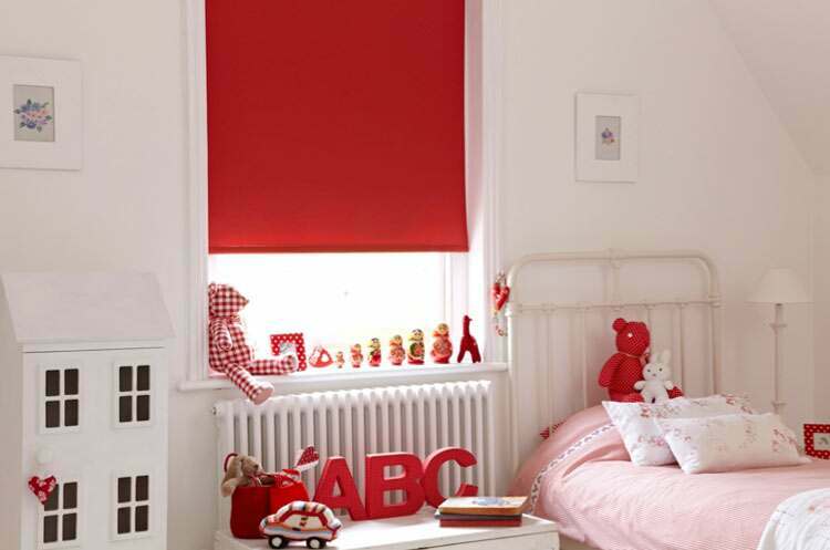 A lovely bedroom acentuated with bright red blinds