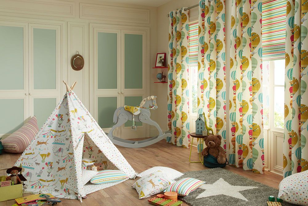 Childrens bedroom with a tent made from the fabric that twins with the main curtain fabric.