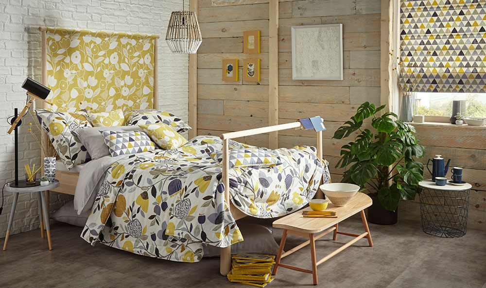 Assorted bedding, blinds and headboard based on the same mustard feature colouring.