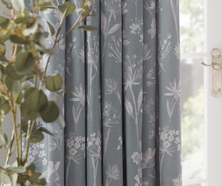 A closeup of a blue flowery curtain