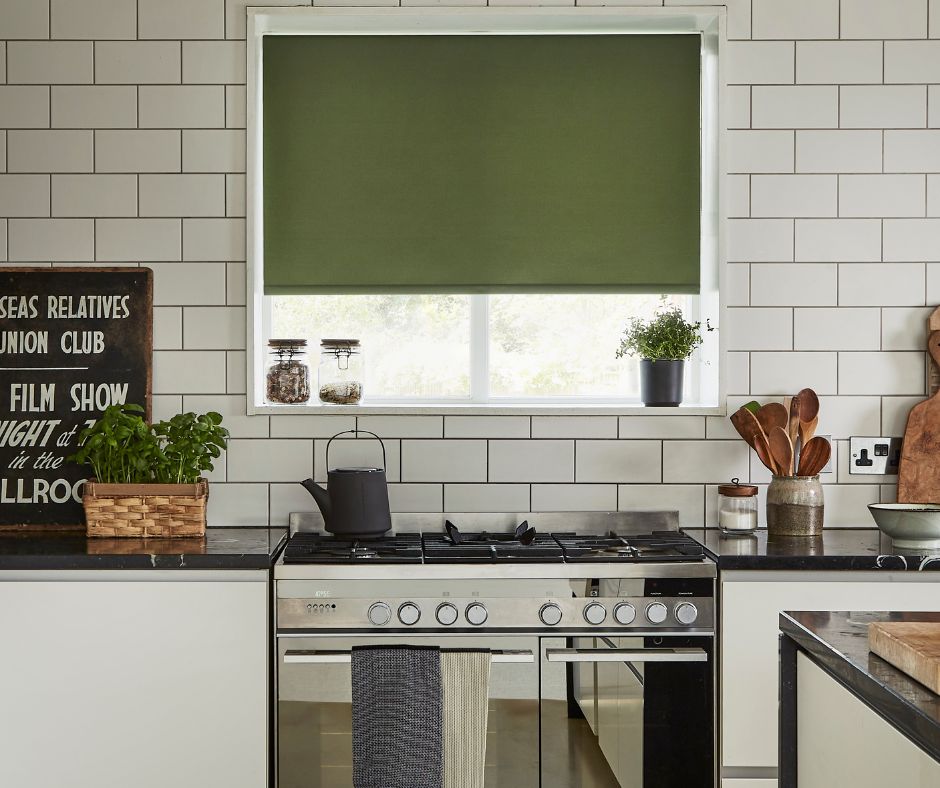 A green roller blind in a modern kitchen window
