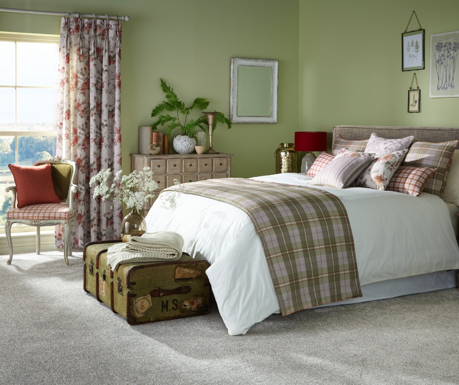 A bright bedroom with green walls and red furniture