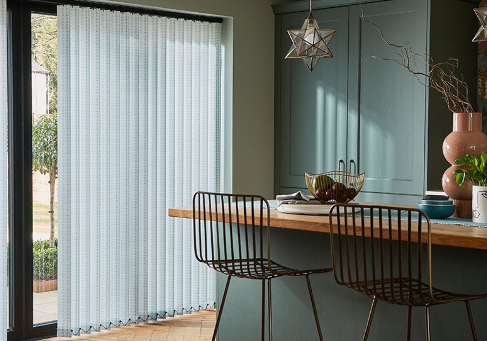 A modern kitchen eating space with vertical blinds in a sliding door