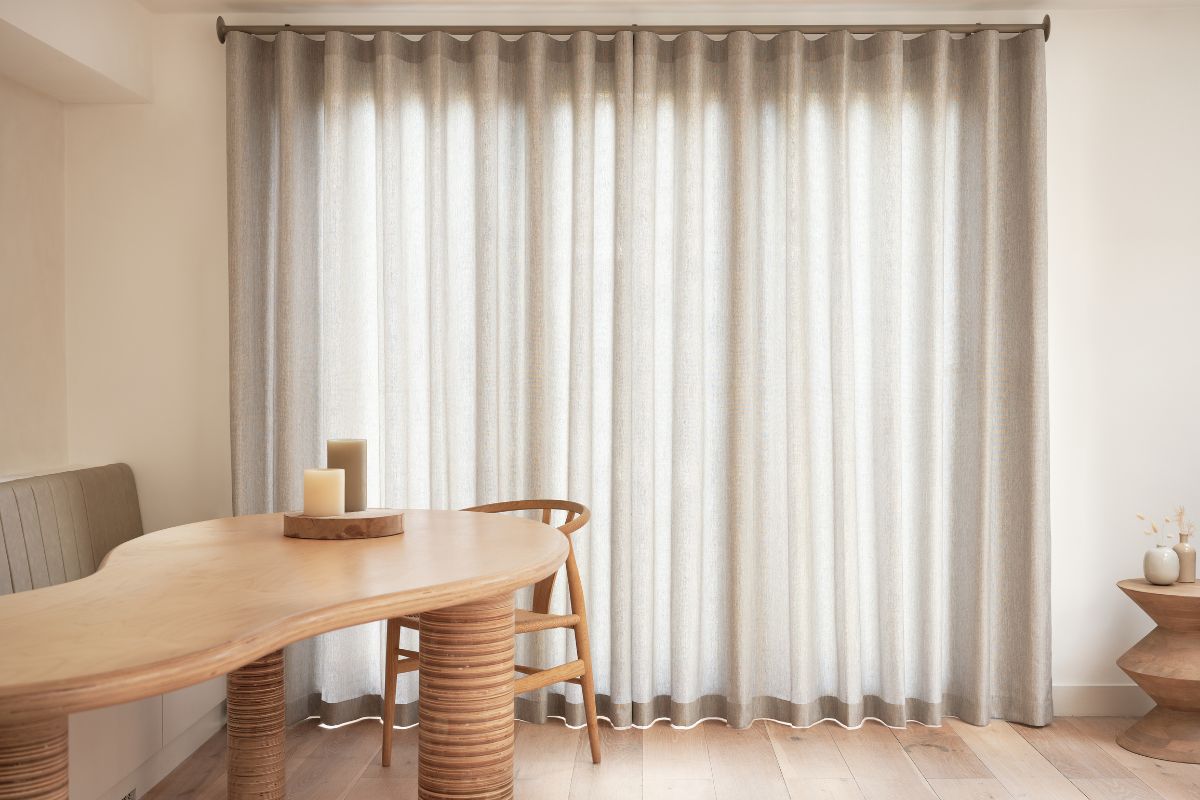 A sand coloured Silent Gliss metropole - pole integrated track in a modern living room